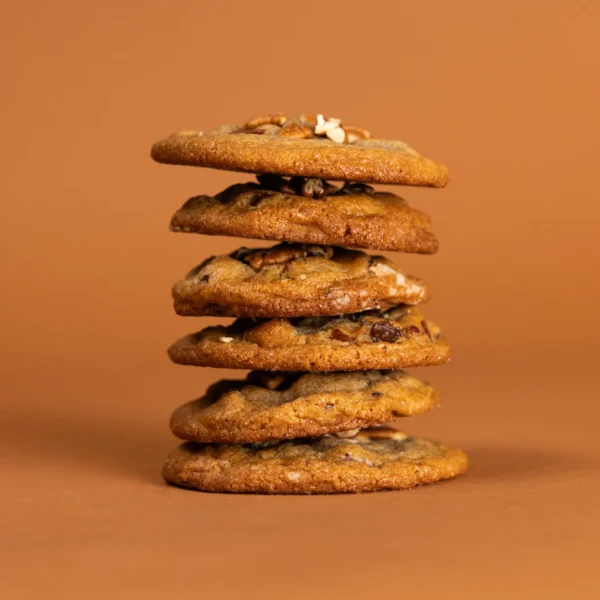 Gourmet homemade Dark Chocolate Pecan cookies on a cooling rack