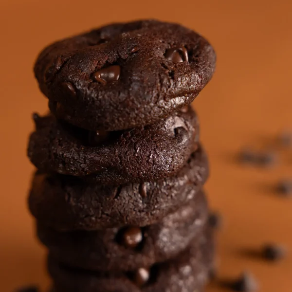 Freshly baked Double Dark Chocolate Chip cookies cooling on a wire rack